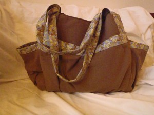 Ingrid! Lined with a high quality cotton in olive green and trimmed out with a sweet and subtle butterfly fabric. Priced at $75