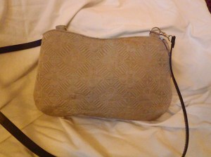 A zip-top twist on a Penelope silhouette. It has a long black leather strap making it a great shoulder or cross-body bag. Priced at $50