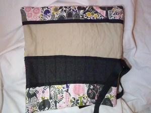 A knitting roll. Hold EVERYTHING that a knitter needs. Room for a ruler, scissors and all your needles. It has a needle guard on the top and rolls up to keep everything in place. Priced at $30.