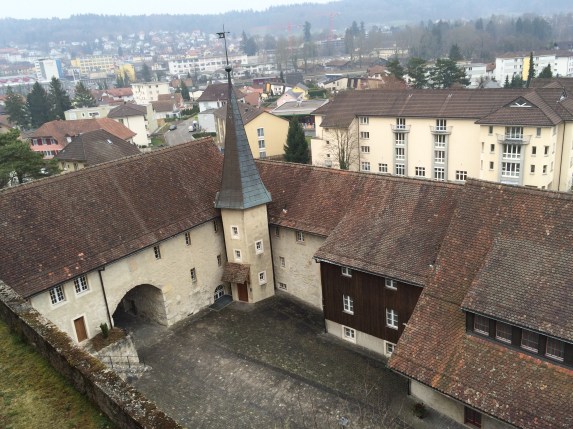 The lower abbey area with a huge wall that goes around it, as if it were a castle courtyard.