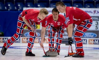 Norway skip Thomas Ulsrud, center, keeps his eye on his shot as Christoffer Svae, right, and Havard Vad Petersson sweep during an morning draw against Scotland at the mens world curling championships in Victoria, British Columbia, Wednesday, April 3, 2013. (AP Photo/The Canadian Press, Jonathan Hayward) ORG XMIT: JOHV117